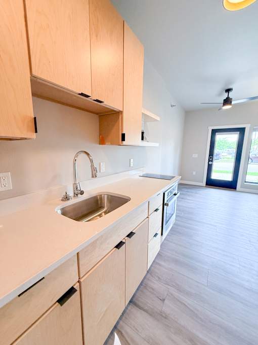 A kitchen with wooden cabinets and a sink.