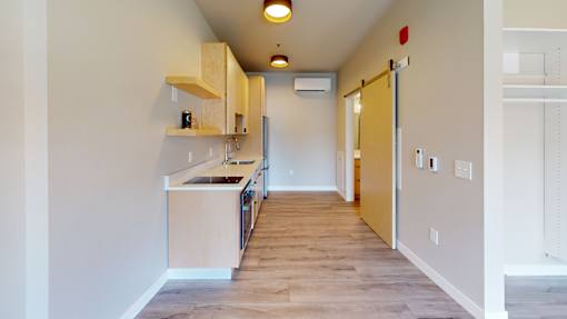 A kitchen area with a sink and cabinets.