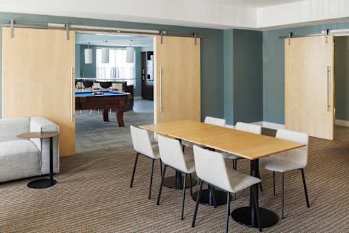 A conference room with a long table and chairs.
