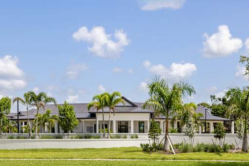 a large house with palm trees in front of it