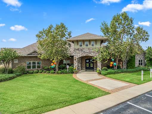 A house with a driveway and a green lawn. at The Villas at Nature Walk, Huntsville, 35824