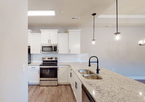 A kitchen with a sink and a counter. at The Villas at Nature Walk, Huntsville, AL