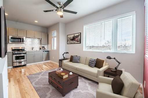 A living room with a white couch and a coffee table.