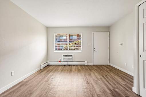 A room with a window and a door.