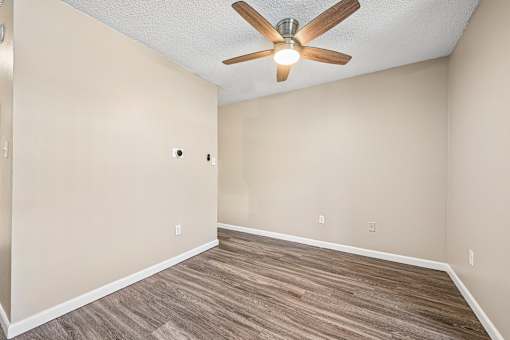 A room with a ceiling fan and light fixture.