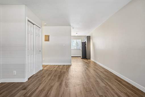 A room with wooden floors and white walls.
