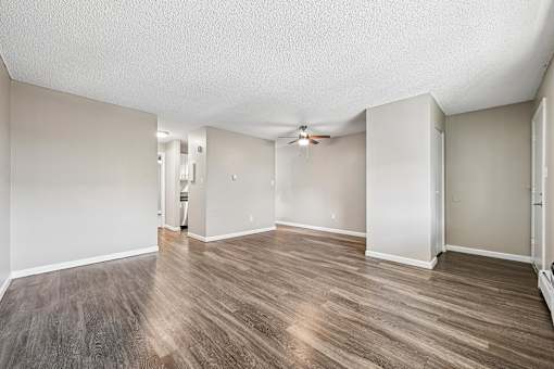 A room with wooden flooring and a ceiling fan.