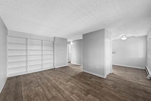 A room with a wooden floor and white walls.
