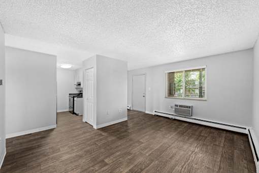 A room with wooden floors and white walls.