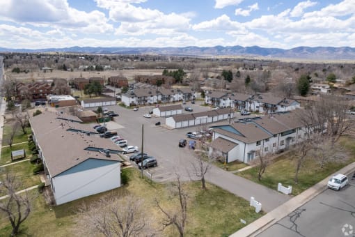arial view of a neighborhood of houses with cars parked in the parking lot