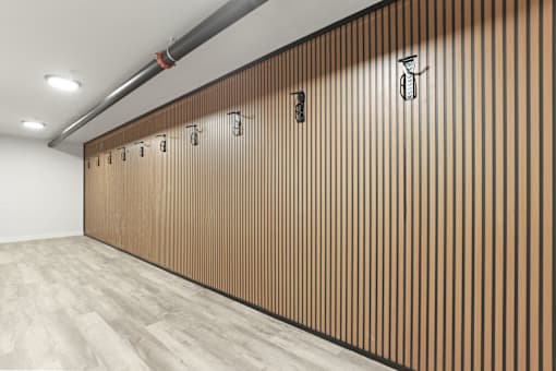 A long hallway with a wood grain wall and a white ceiling.