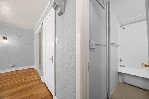 A white door is open to a bathroom.
