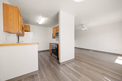 A kitchen with wooden cabinets and a white countertop.