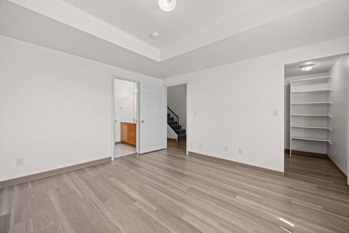 A room with wooden floors and white walls.