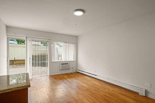 A room with a wooden floor and a marble counter top.