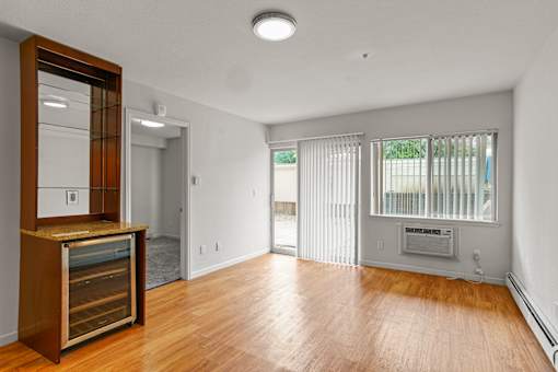 A room with a wooden floor and a wine cooler.