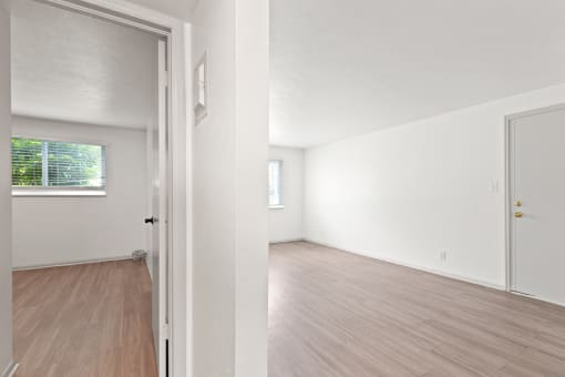 the spacious living room and dining room of an apartment
