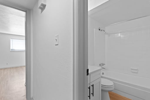 a bathroom with a toilet and a tub and a sink