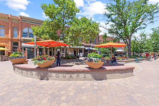 A roundabout with a sign that says "Old Town Square" in the middle.