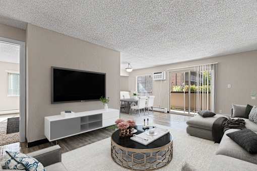 A modern living room with a flat screen TV, a white entertainment center, and a coffee table with a vase of flowers on it.
