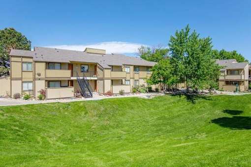 Apartment complex with a green lawn in front.