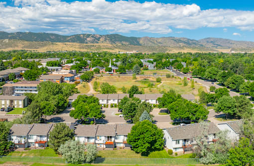 A bird's eye view of a residential area with houses and trees.