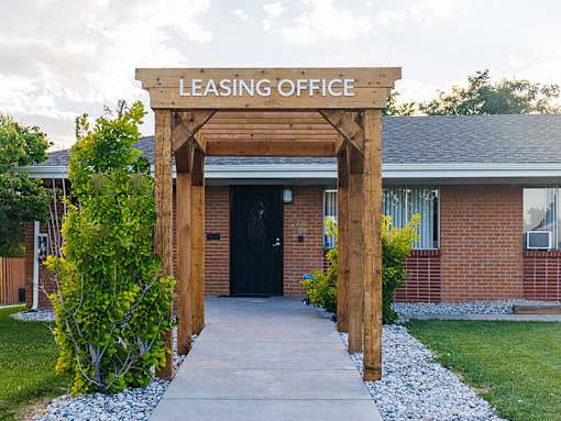 A leasing office is surrounded by a small garden.
