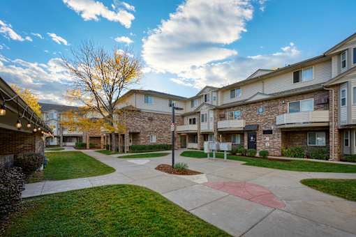 A sunny day at a residential complex with a clear blue sky.