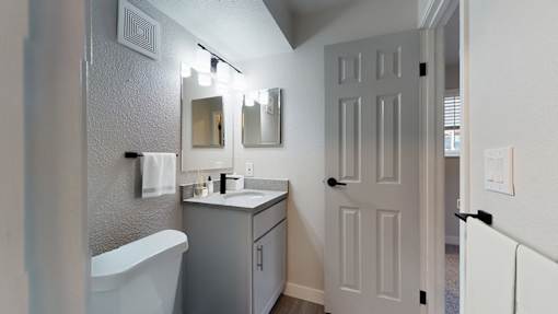 A white bathroom with a white tub and sink.