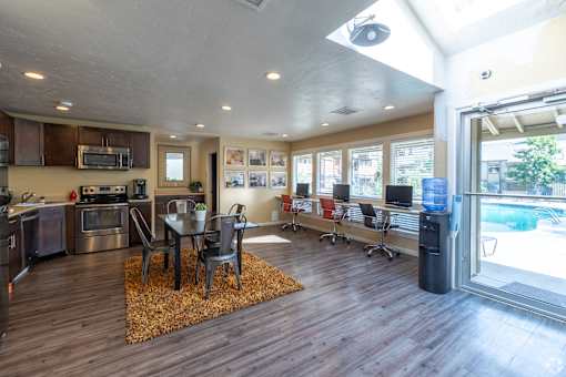 A modern kitchen with a dining table and chairs.