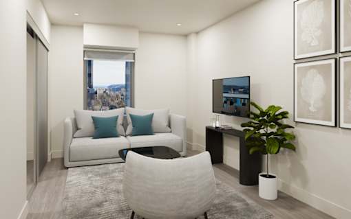 A living room with a white couch, a grey chair, and a television.