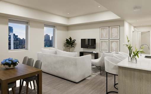 A modern living room with a white couch, a wooden table, and a city view through the windows.