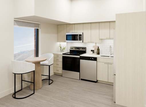A modern kitchen with a white countertop and black appliances.
