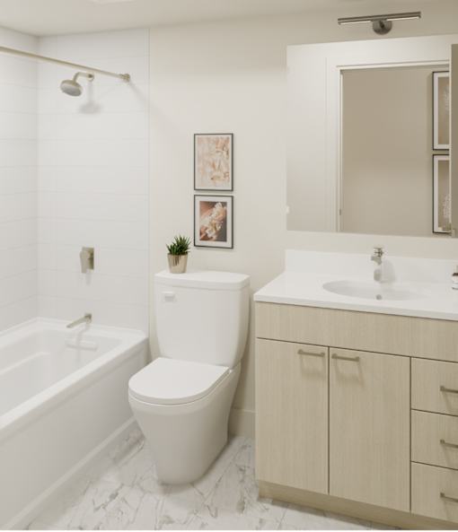 A white toilet sits next to a white sink in a bathroom.