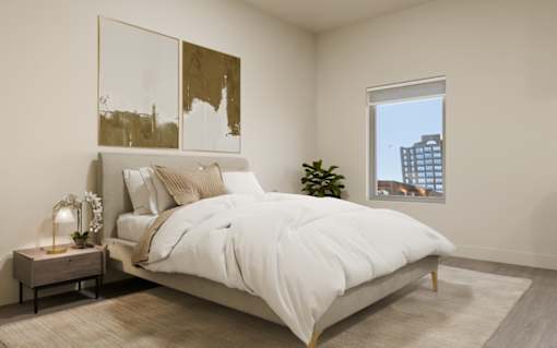 A bedroom with a large bed and a window overlooking a cityscape.