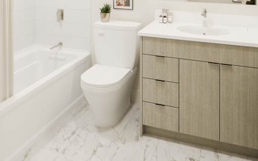 A white toilet sits next to a sink in a bathroom.
