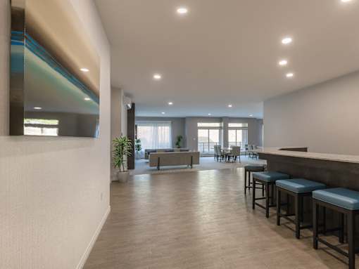 A modern living room with a bar area and a dining table.