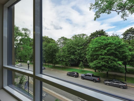 the view of cars parked on the street from a window