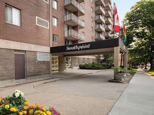 The entrance to a building named Southpoint with a flag on the right side.