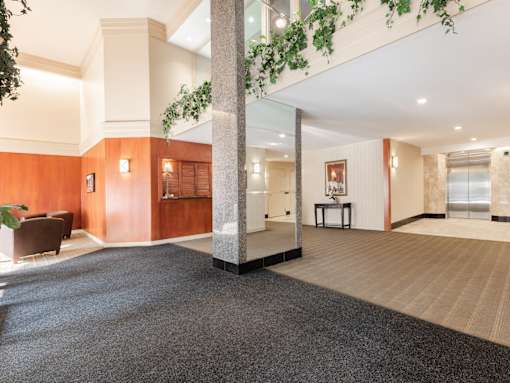 A large open space with a carpeted floor and wooden walls.