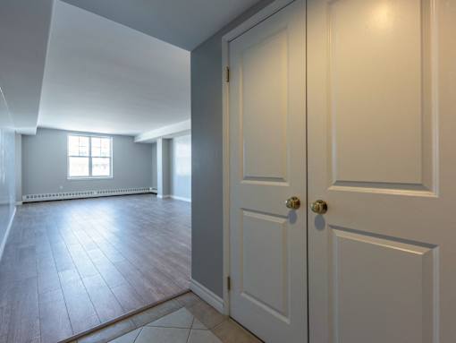 A room with a white door and a window.