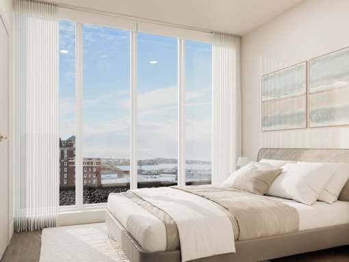 A bedroom with a large bed and a view of the city.