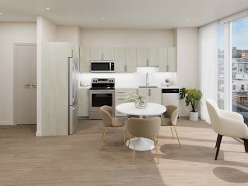 A modern kitchen with a dining table and chairs.