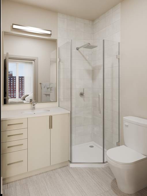 A white toilet sits in a bathroom next to a walk-in shower.