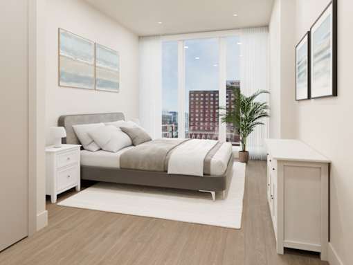 A bedroom with a large bed, a nightstand, and a cabinet.