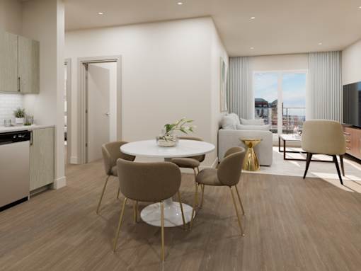 A modern dining room with a round table and chairs.