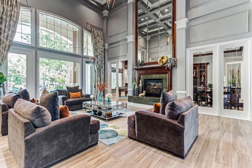 Townhomes Aurora, IL - Kirkland Crossing - Clubhouse with a Fireplace, Floor-to-Ceiling Windows, and Seating Area