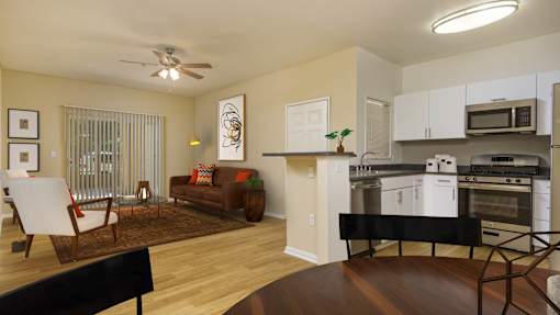 A modern kitchen with a dining area and a living room.