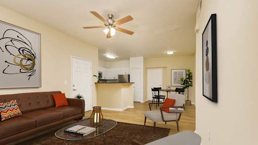 A living room with a brown couch and a ceiling fan.