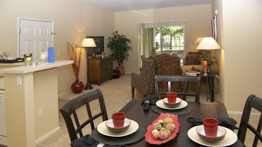 A dining room with a table set for two.